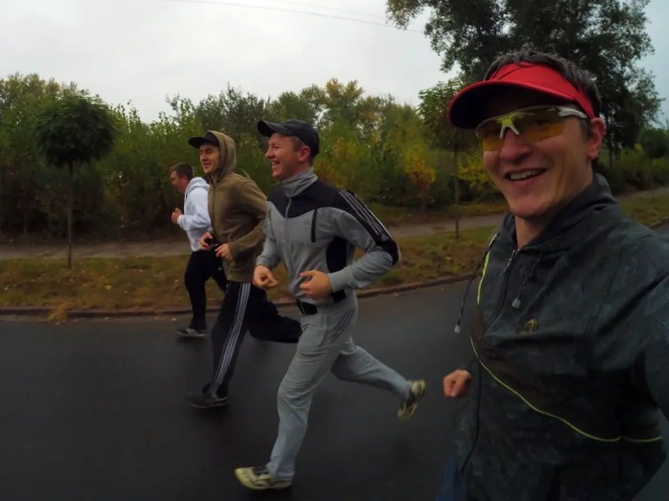 Vova, Viacheslav, Vlad, and Roma running along the Dnieper river heading to the Sosnovy Bir Park